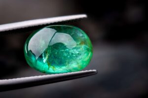 The emerald gemstone jewelry photo with dark lighting background.